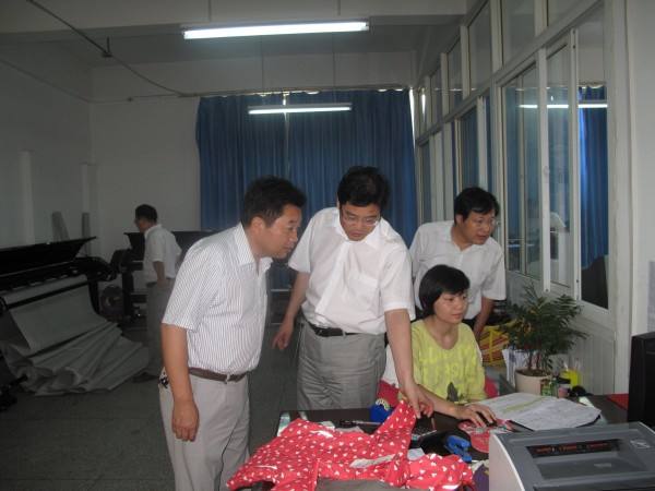 员工围绕工作台进行现场交流